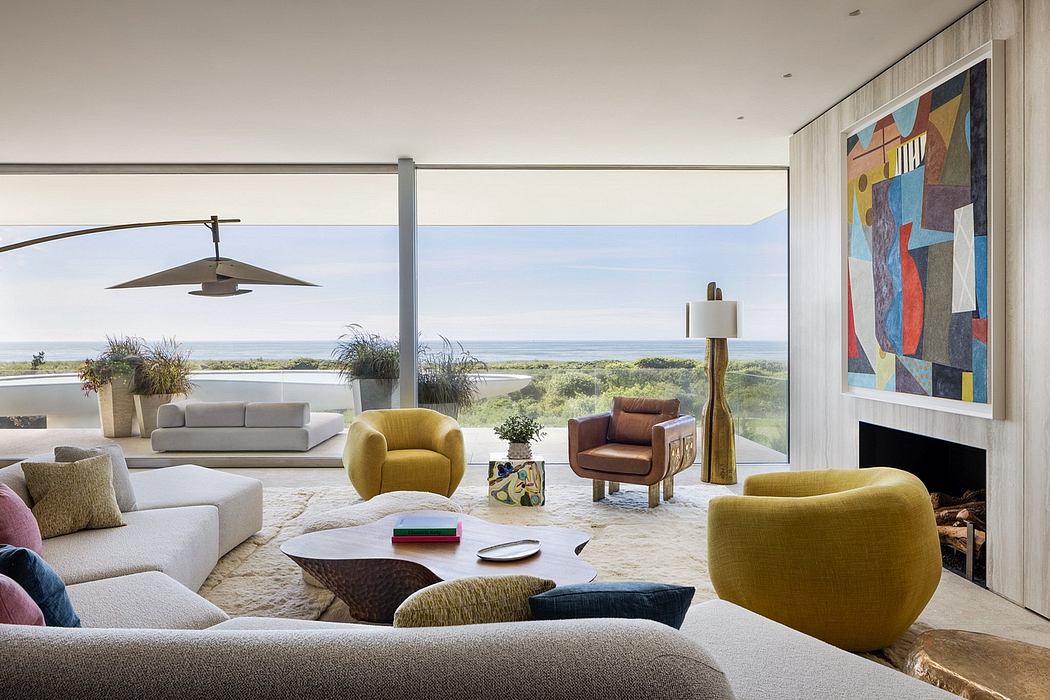 Spacious living room with panoramic ocean view, contemporary furnishings, and vibrant artwork.