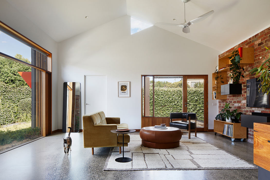 Spacious living area with high ceilings, large windows, and a mix of modern and vintage furniture.