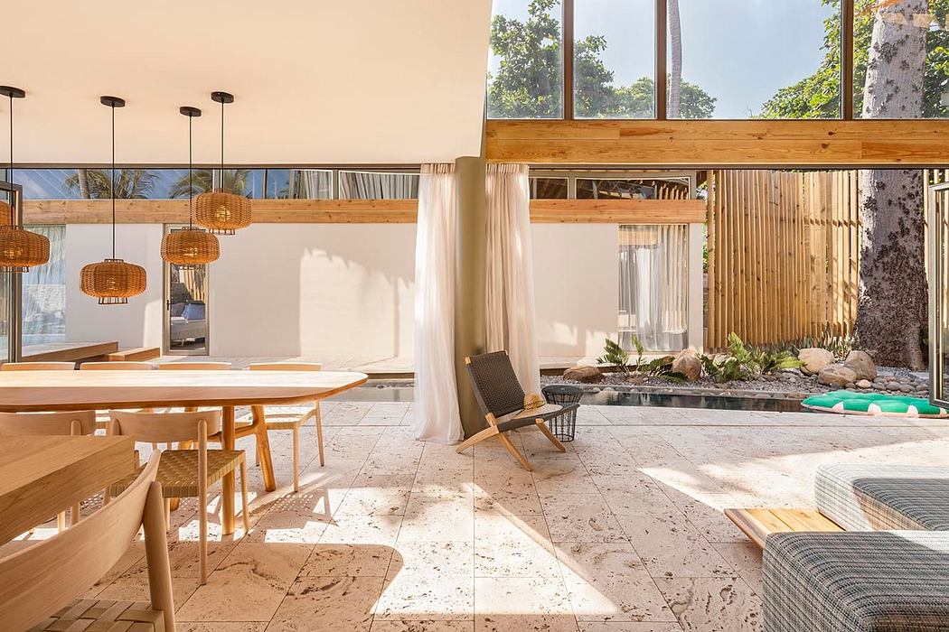 Outdoor lounge area with wooden beams, rattan lamps, and a small pool surrounded by stone tiles.