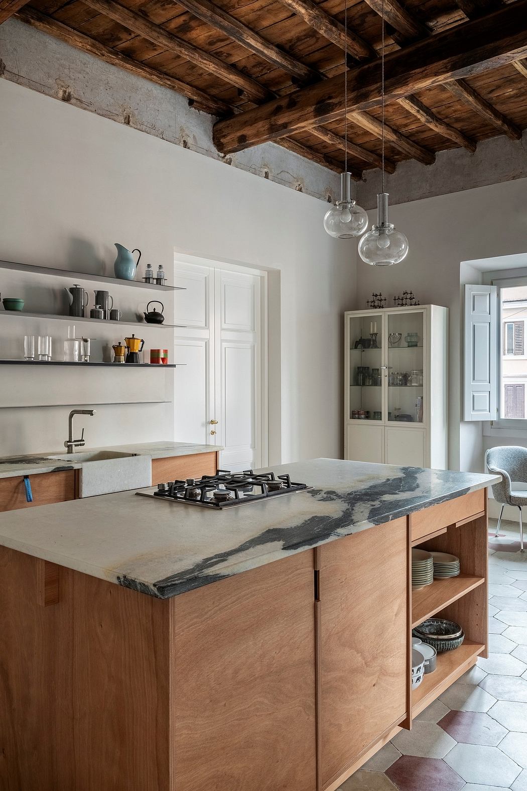 Warm, rustic kitchen with wooden ceiling beams, modern marble countertops, and open shelving.