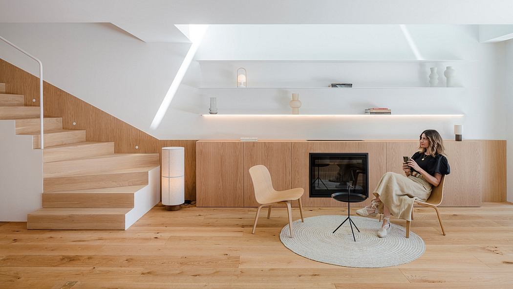 A modern, minimalist living space with clean lines, warm wood accents, and recessed lighting.