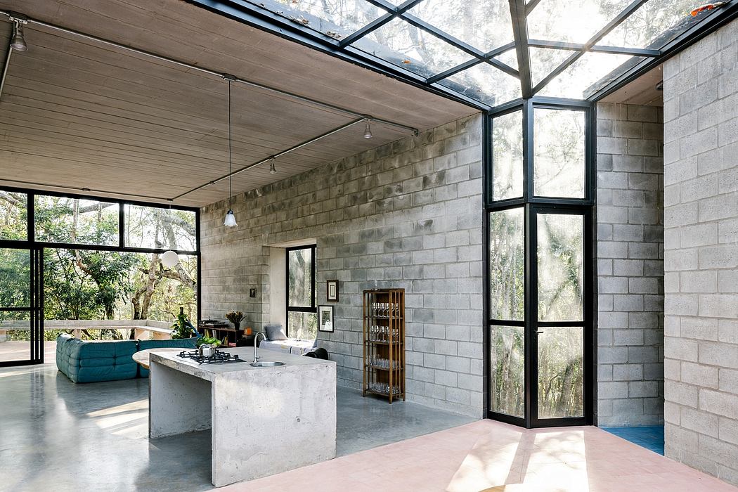 A spacious, modern interior with concrete walls, large windows, and a glass-paneled ceiling.