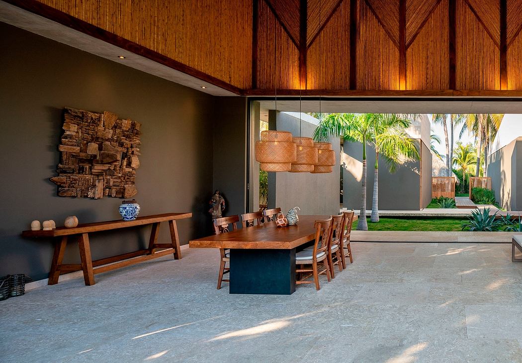 Expansive dining room with wooden beams, contemporary furnishings, and views of lush outdoor greenery.
