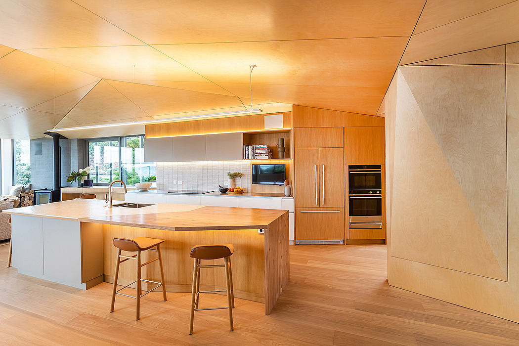 Sleek, modern kitchen with wood paneling, island, and integrated appliances.