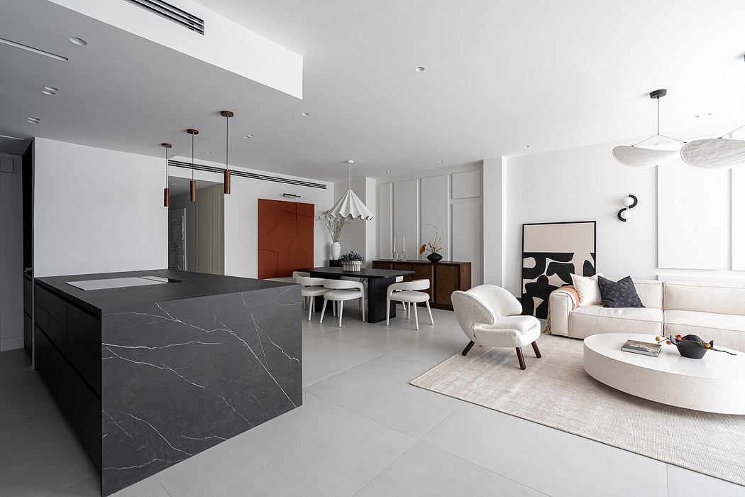Sleek, modern interior with marble kitchen island, warm lighting, and minimalist furnishings.