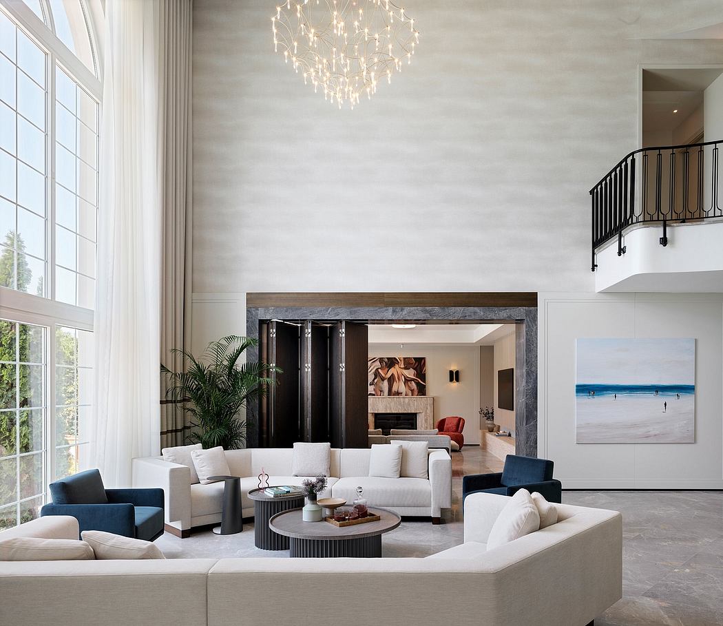 Spacious living room with modern furnishings, large windows, and a statement chandelier.