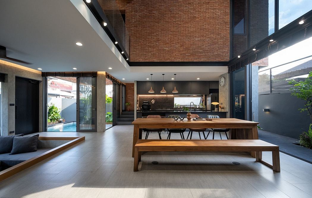 Expansive open-concept living space with exposed brick walls, wooden furnishings, and natural light.