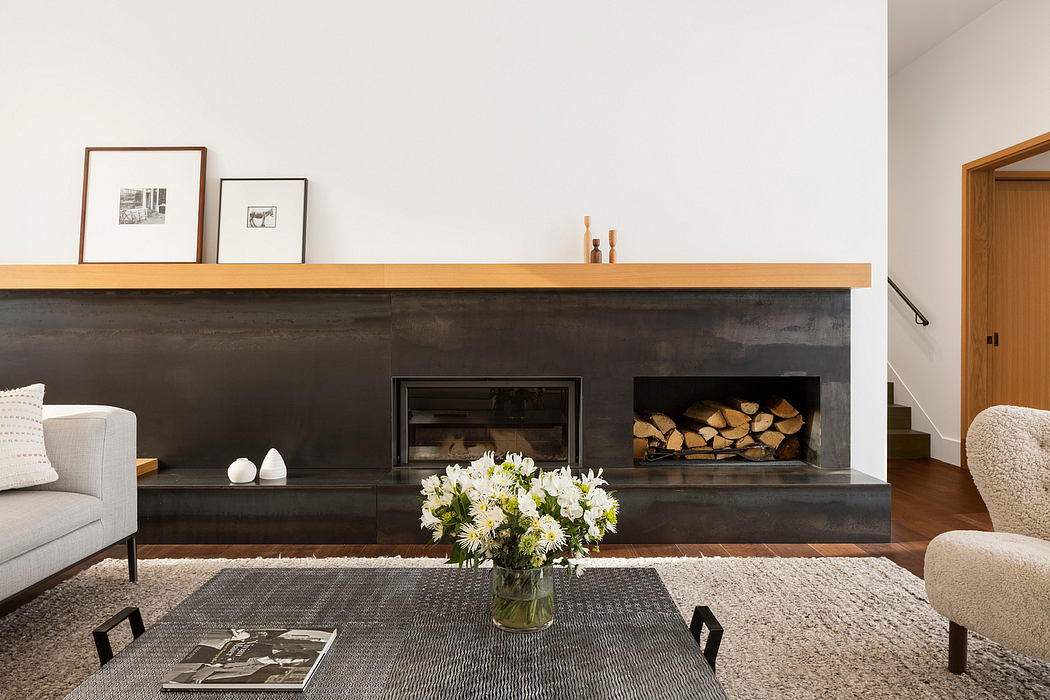 Minimalist living room with a sleek fireplace, wooden shelves, and a floral centerpiece.
