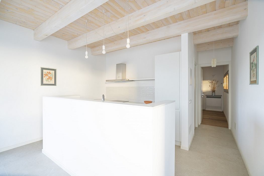 Modern kitchen with white cabinetry, wooden ceiling beams, and a spacious layout.