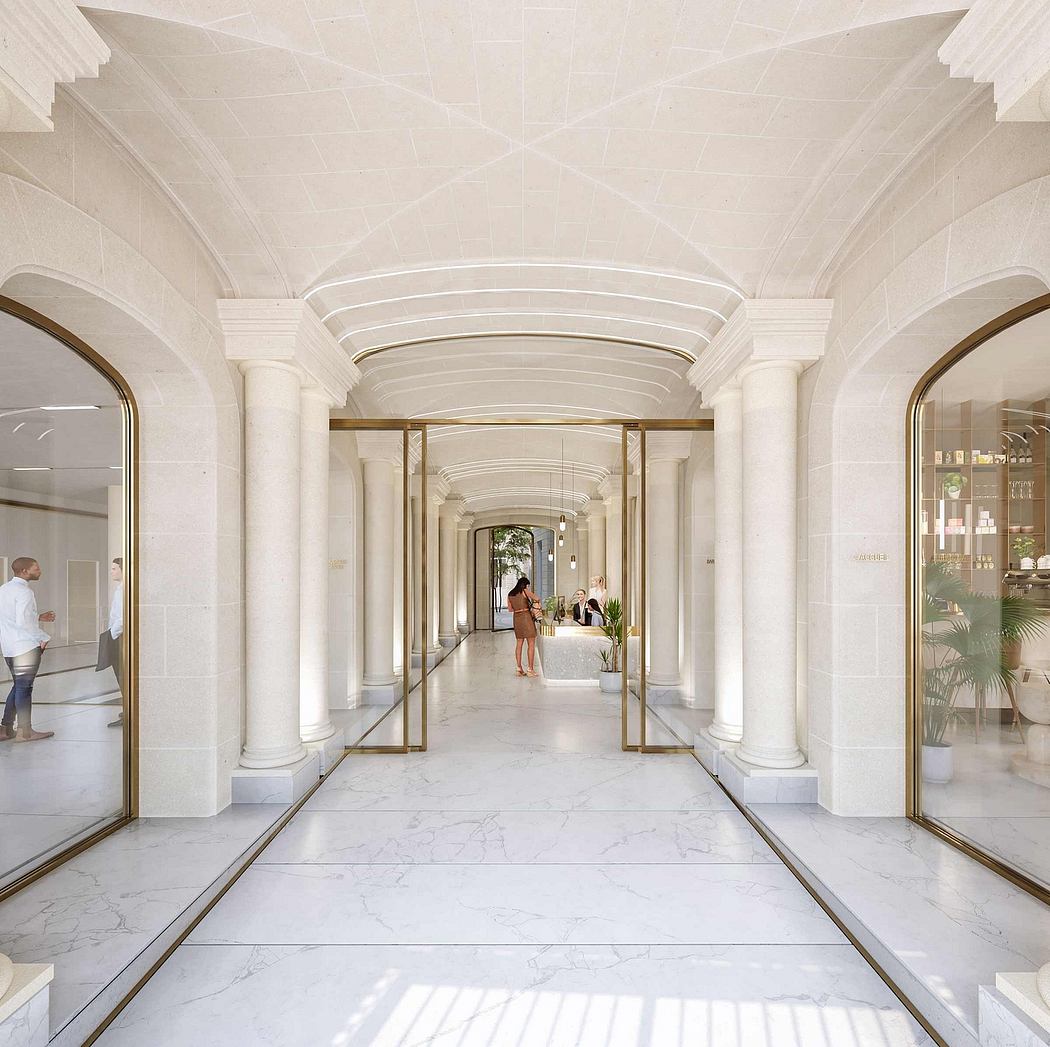 Ornate arched ceiling, white marble floors, and brass detailing create a grand, elegant interior.