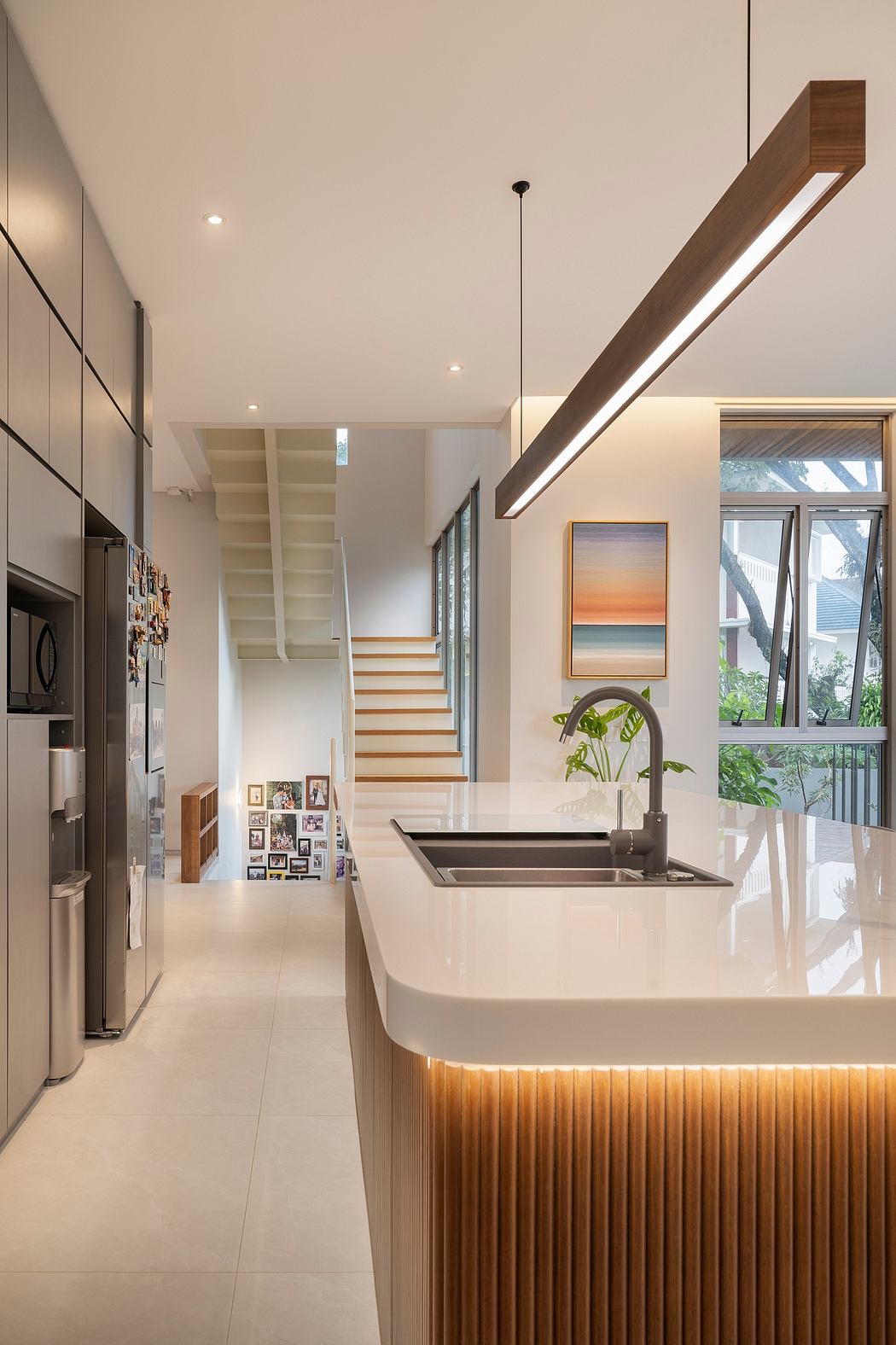 Modern kitchen with sleek cabinetry, recessed lighting, and a wooden overhead beam for a warm, inviting atmosphere.