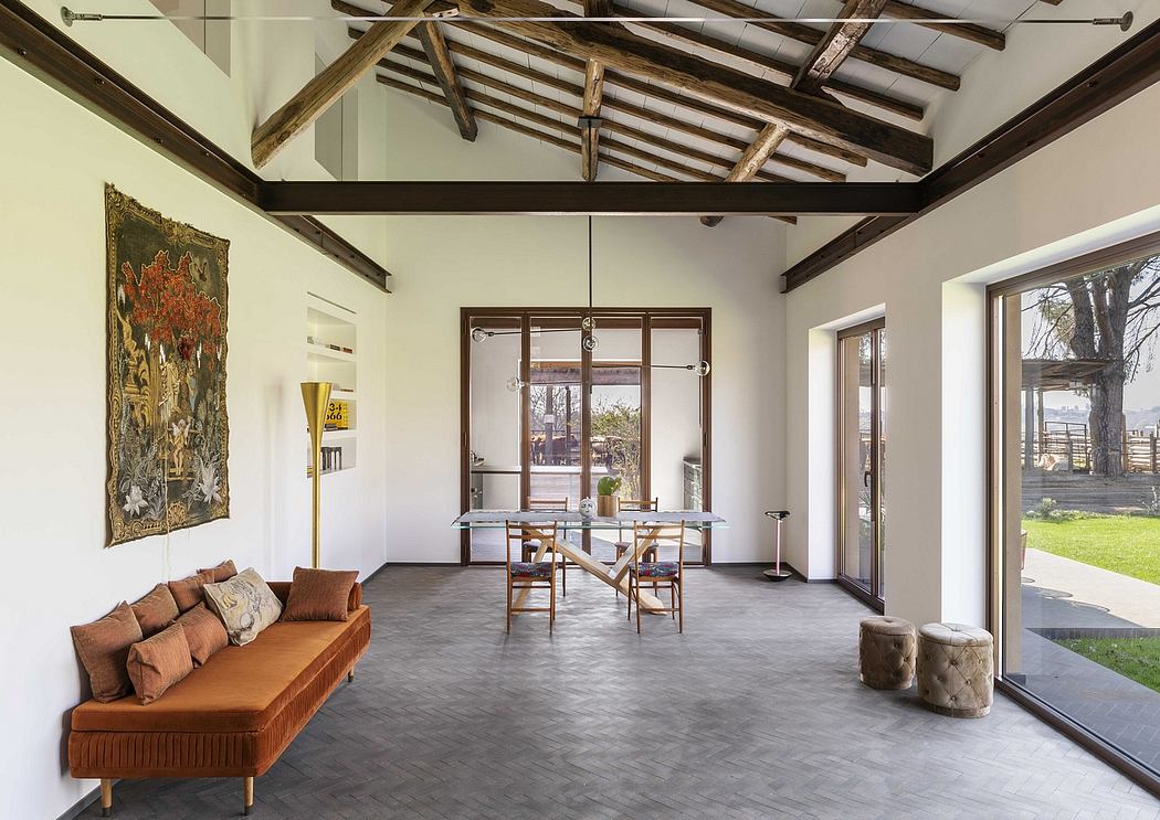 A spacious room with a high vaulted ceiling, exposed wooden beams, and a modern interior design.