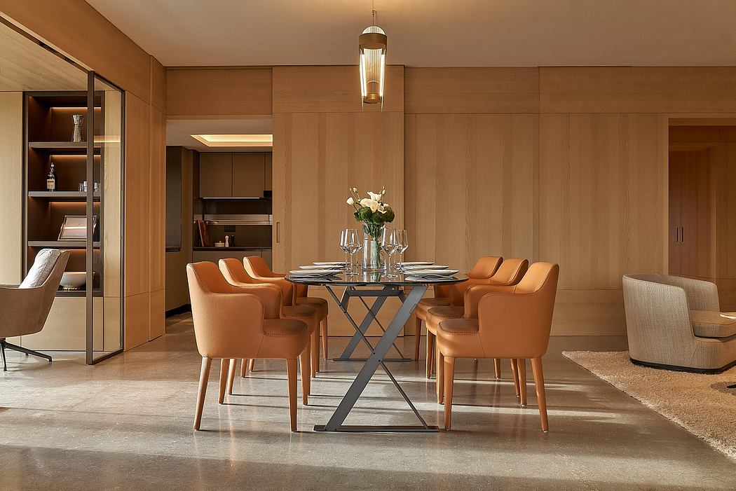 Well-lit dining room with wood-paneled walls, contemporary furniture, and a hanging light fixture.
