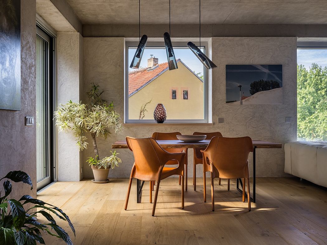 Warm, modern dining space with wood furniture, large window, and vibrant wall art.