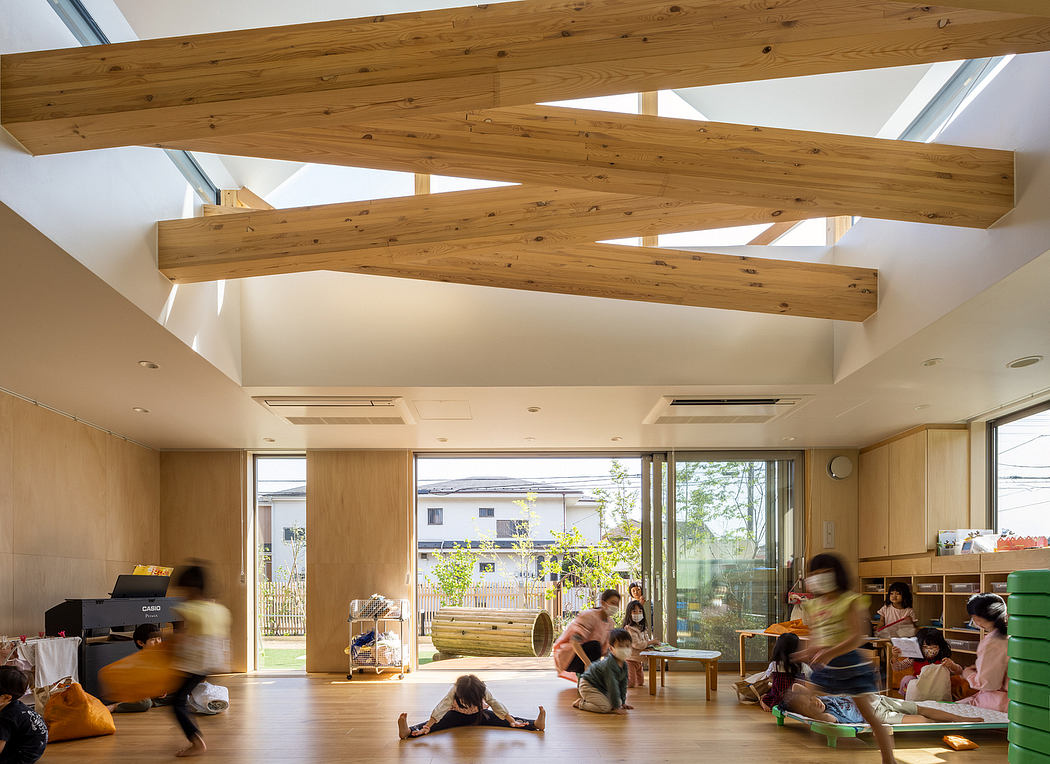 Bright, open interior with wood-beamed ceiling and glass walls overlooking a garden.