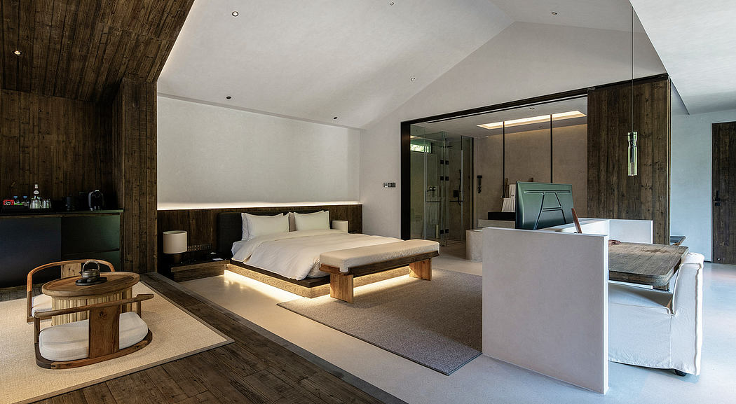 Spacious modern bedroom with wood-paneled walls, elevated bed platform, and sleek furnishings.
