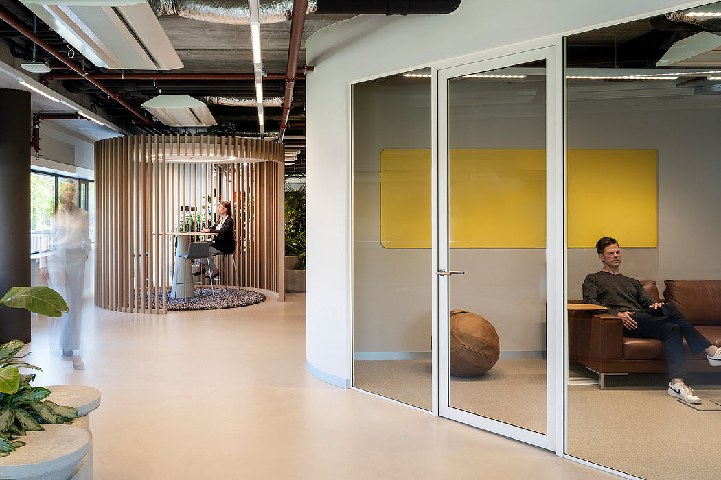 Modern office space with sleek furniture, glass walls, and vibrant design elements.