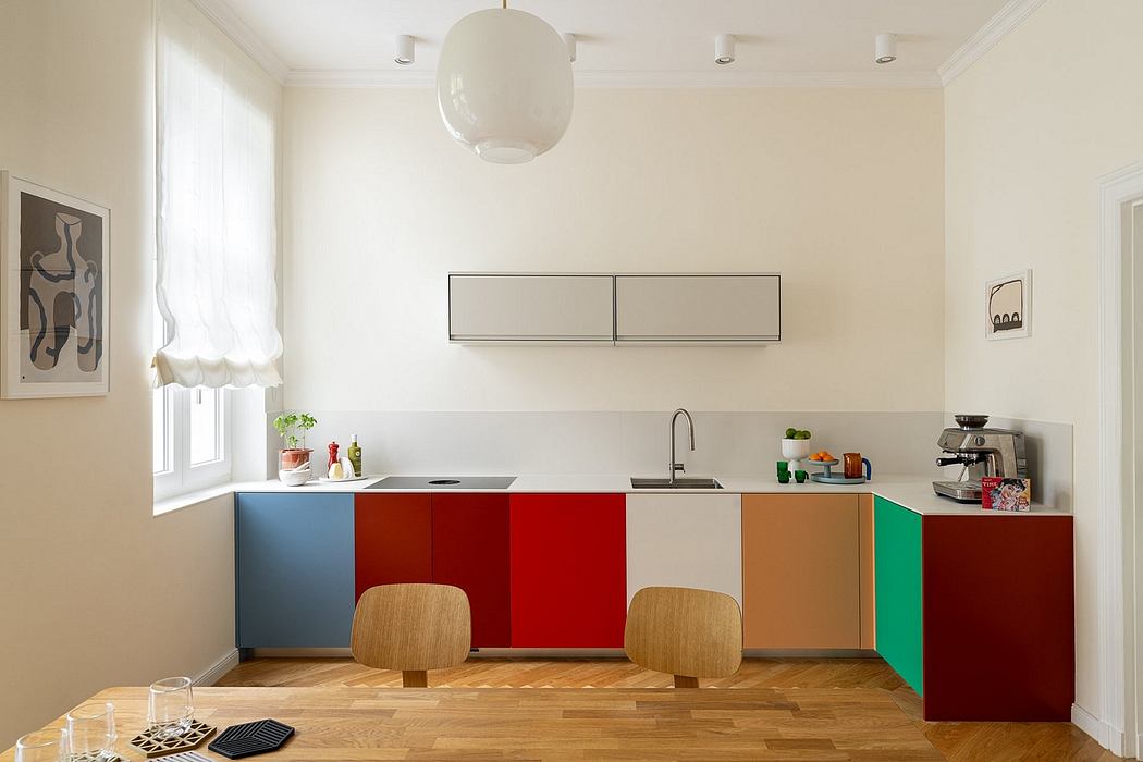 A bright, modern kitchen with colorful, streamlined cabinets and minimalist decor.