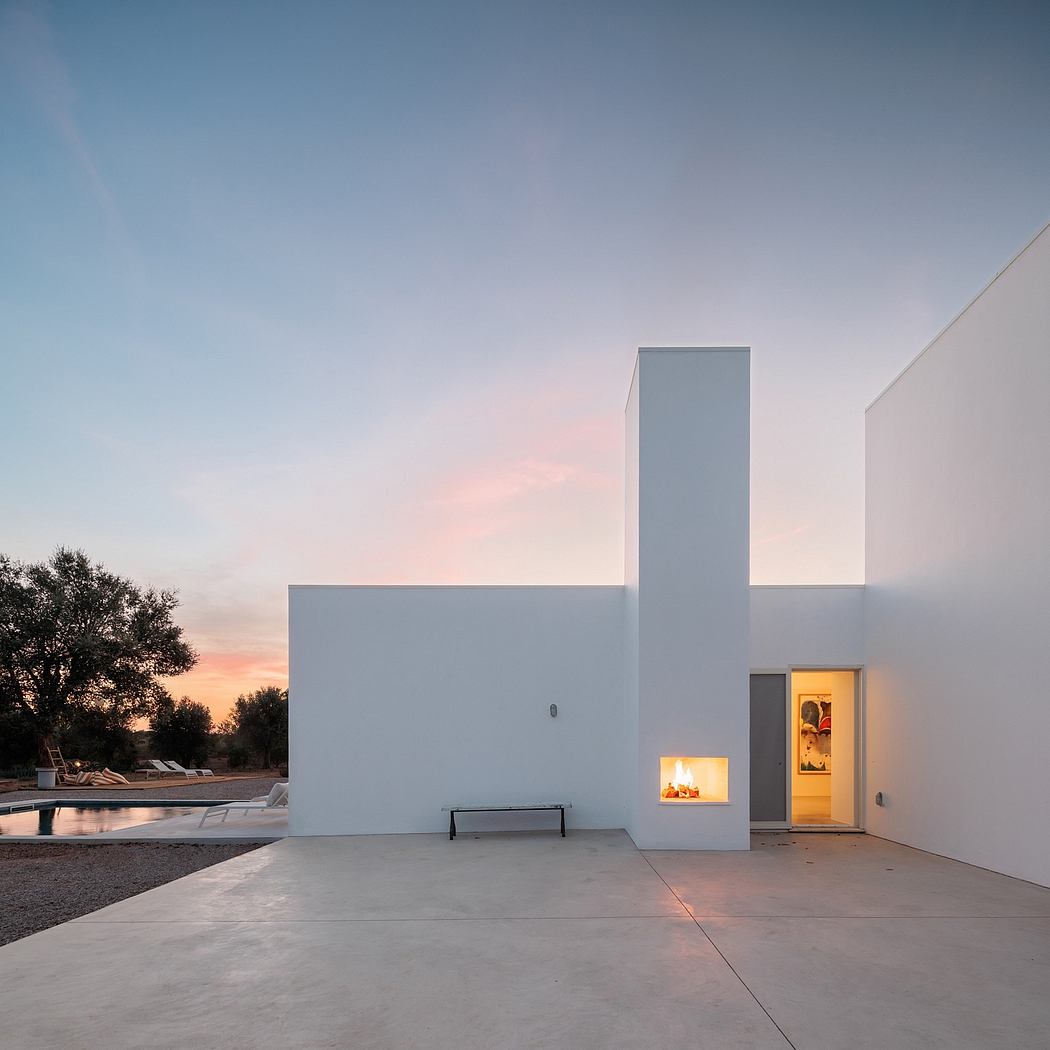 Minimalist architecture with clean lines, large windows, and a cozy fireplace at sunset.
