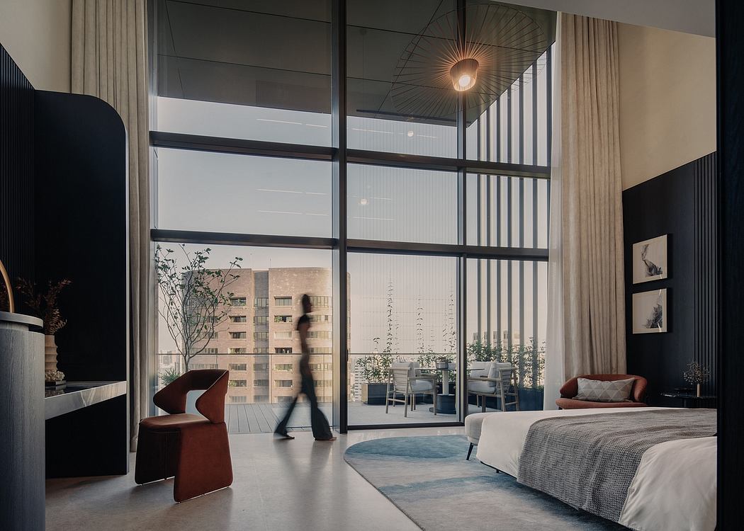 Minimalist bedroom with floor-to-ceiling windows, modern furniture, and a blurred figure.