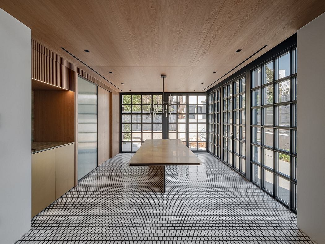 Elegant modern interior with wood-paneled ceiling, large windows, and patterned tile floor.