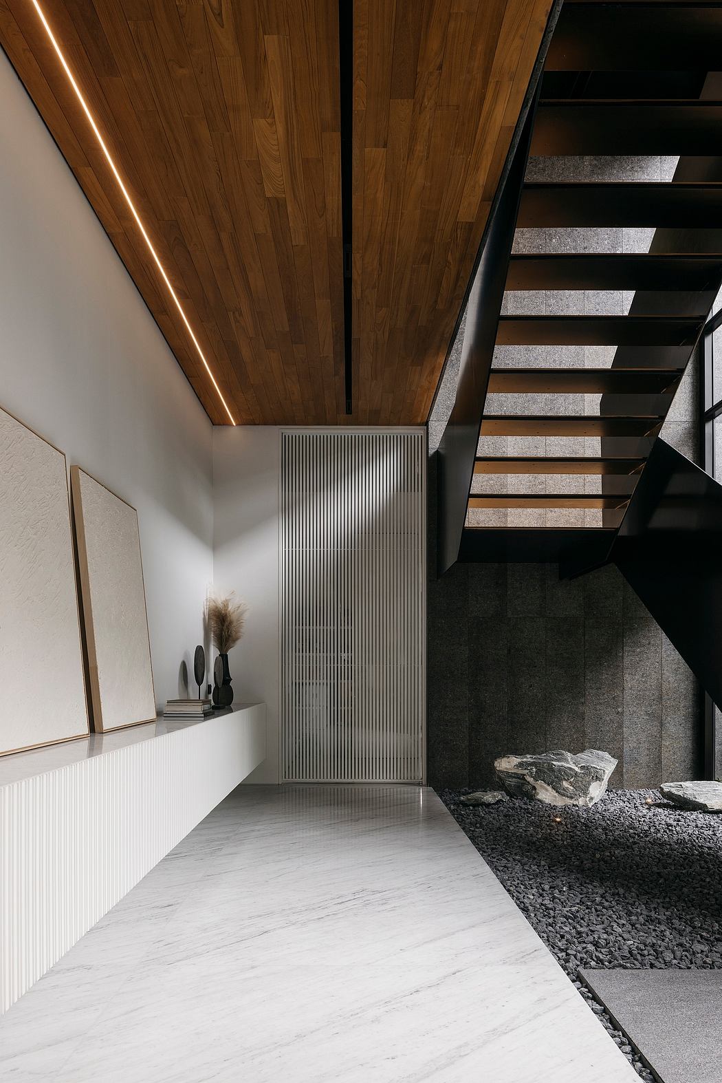 A modern foyer with wooden ceiling, concrete stairs, and minimalist decor accents.