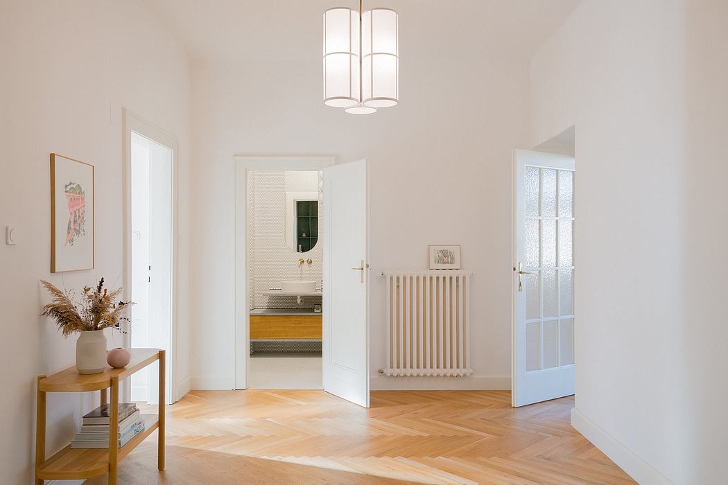 Bright, spacious room with clean lines, herringbone wood floors, and minimalist decor.