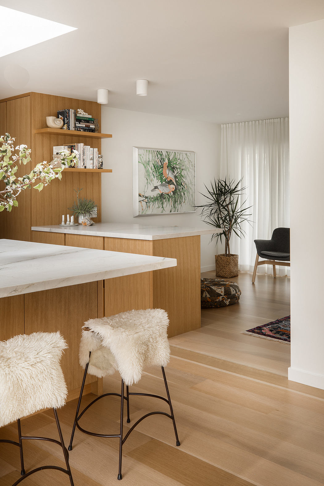 Minimalist kitchen with wood cabinetry, shelving, and modern furnishings.