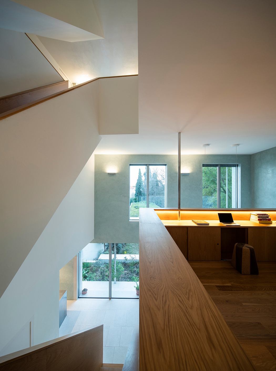 Sleek modern interior with warm wood accents, geometric lighting, and expansive views.