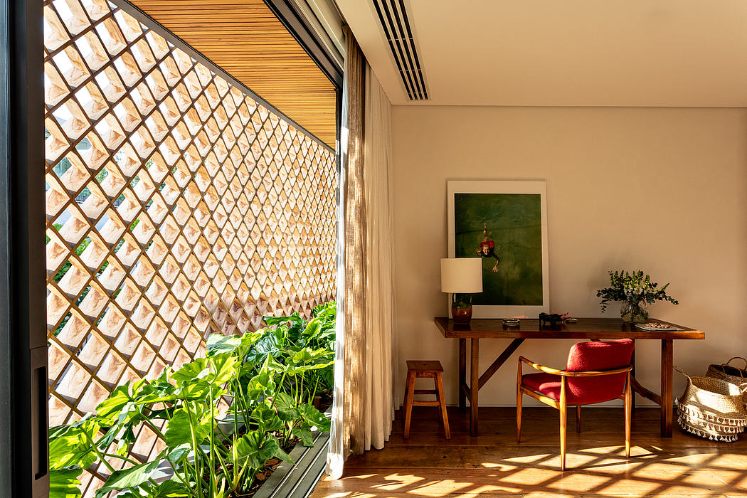 Warm, sun-filled room with wooden lattice walls, desk, and vibrant plant life.