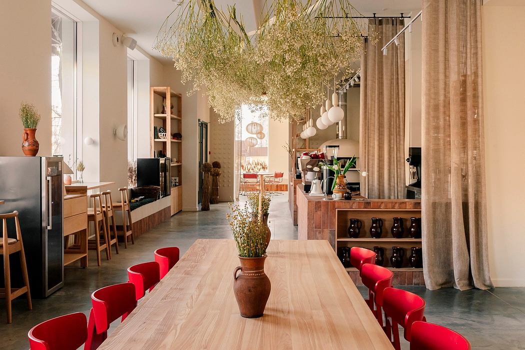 A modern, open-concept dining area with a lush, vibrant floral installation as the central focal point.