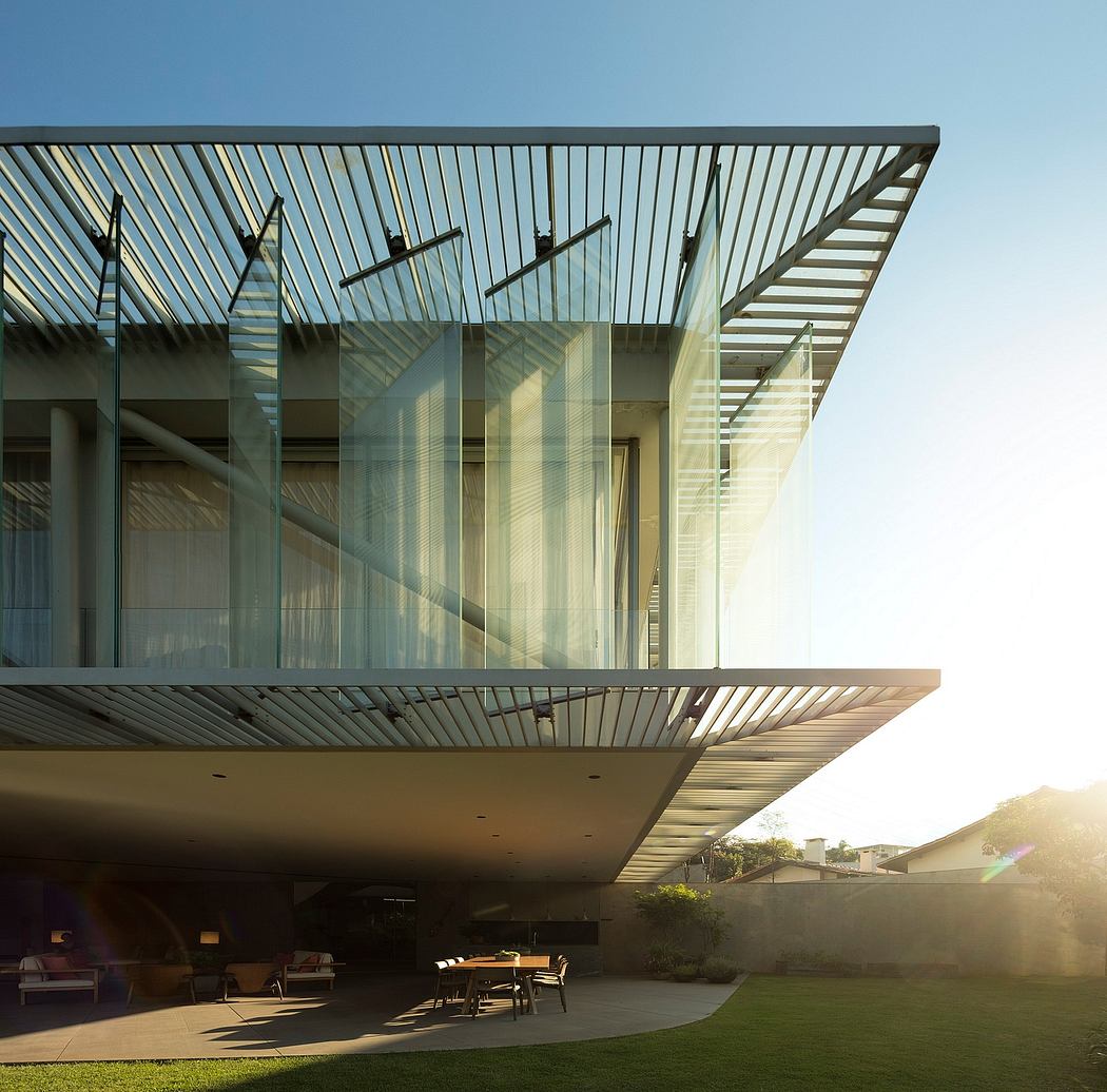 Striking modern architecture with cantilevered roof, glass walls, and outdoor seating area.