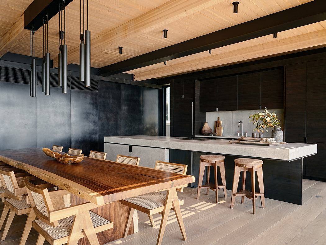 Rustic wooden beams, sleek black cabinets, stone countertop, and modern pendant lighting.