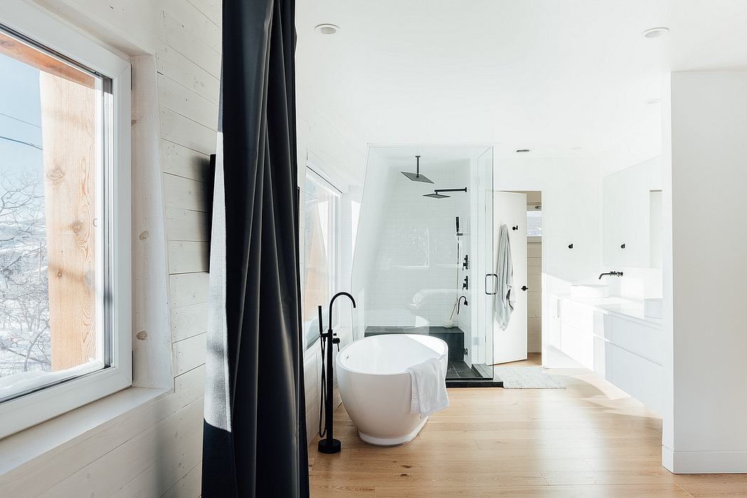 A minimalist bathroom with a freestanding tub, glass-enclosed shower, and exposed wood paneling.