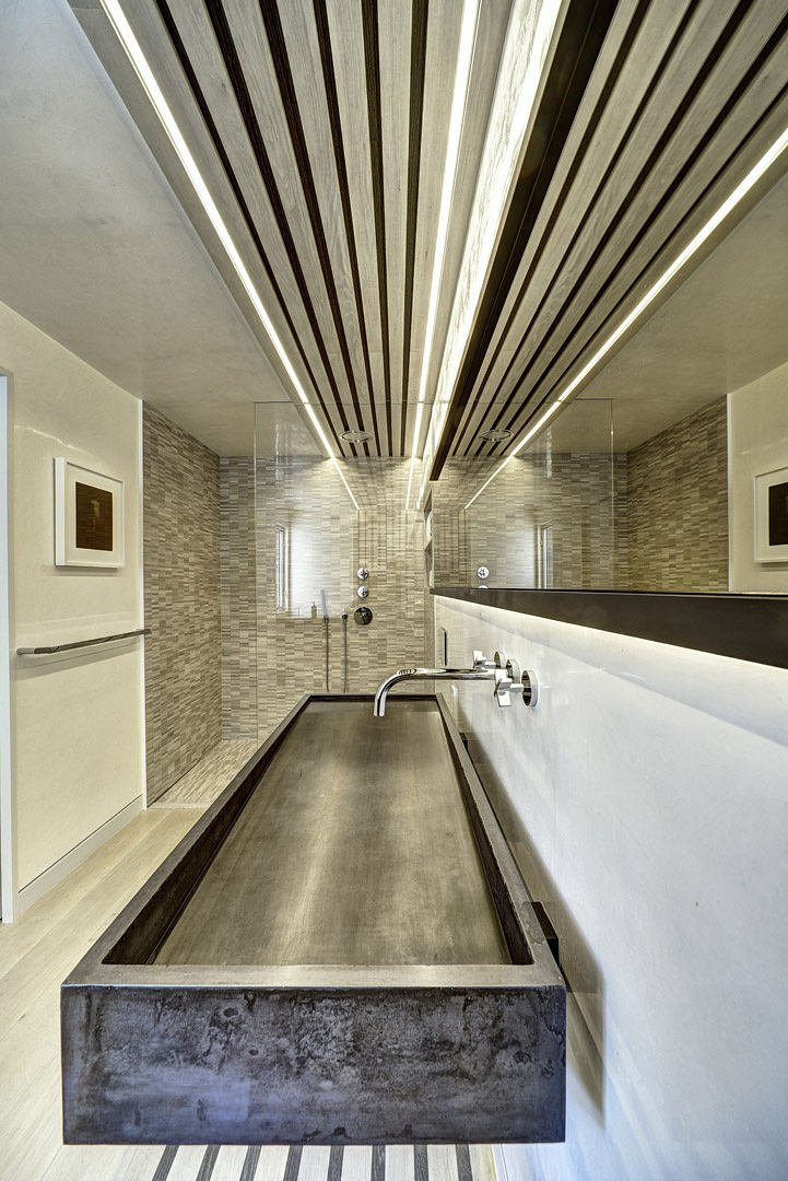 Sleek modern bathroom with concrete vanity, tiled walls, and linear wooden ceiling.