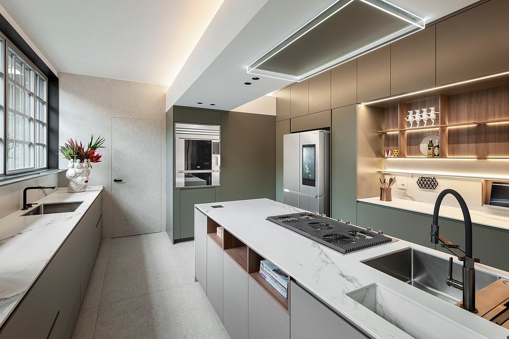 Sleek, modern kitchen with grey cabinetry, integrated appliances, and marble countertops.