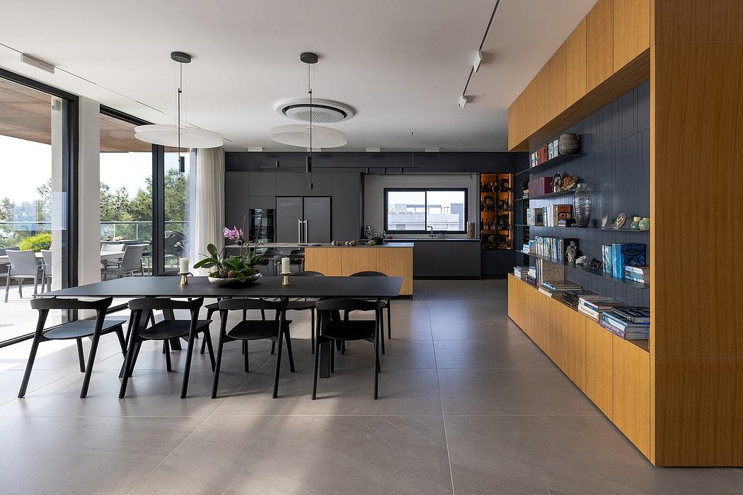 Sleek, modern kitchen and dining area with dark-toned finishes and wood accents.