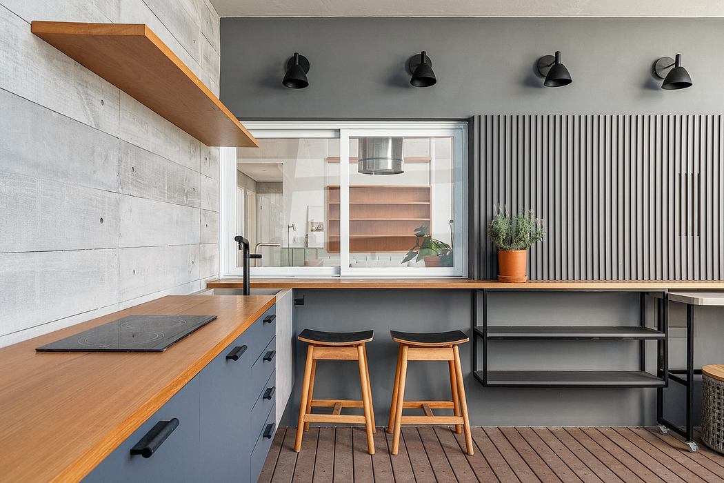 Sleek, industrial-inspired kitchen with wooden countertops, black accents, and minimalist lighting.