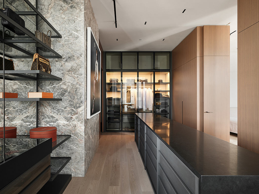 Sleek, modern hallway with floor-to-ceiling glass closets, stone walls, and wooden flooring.