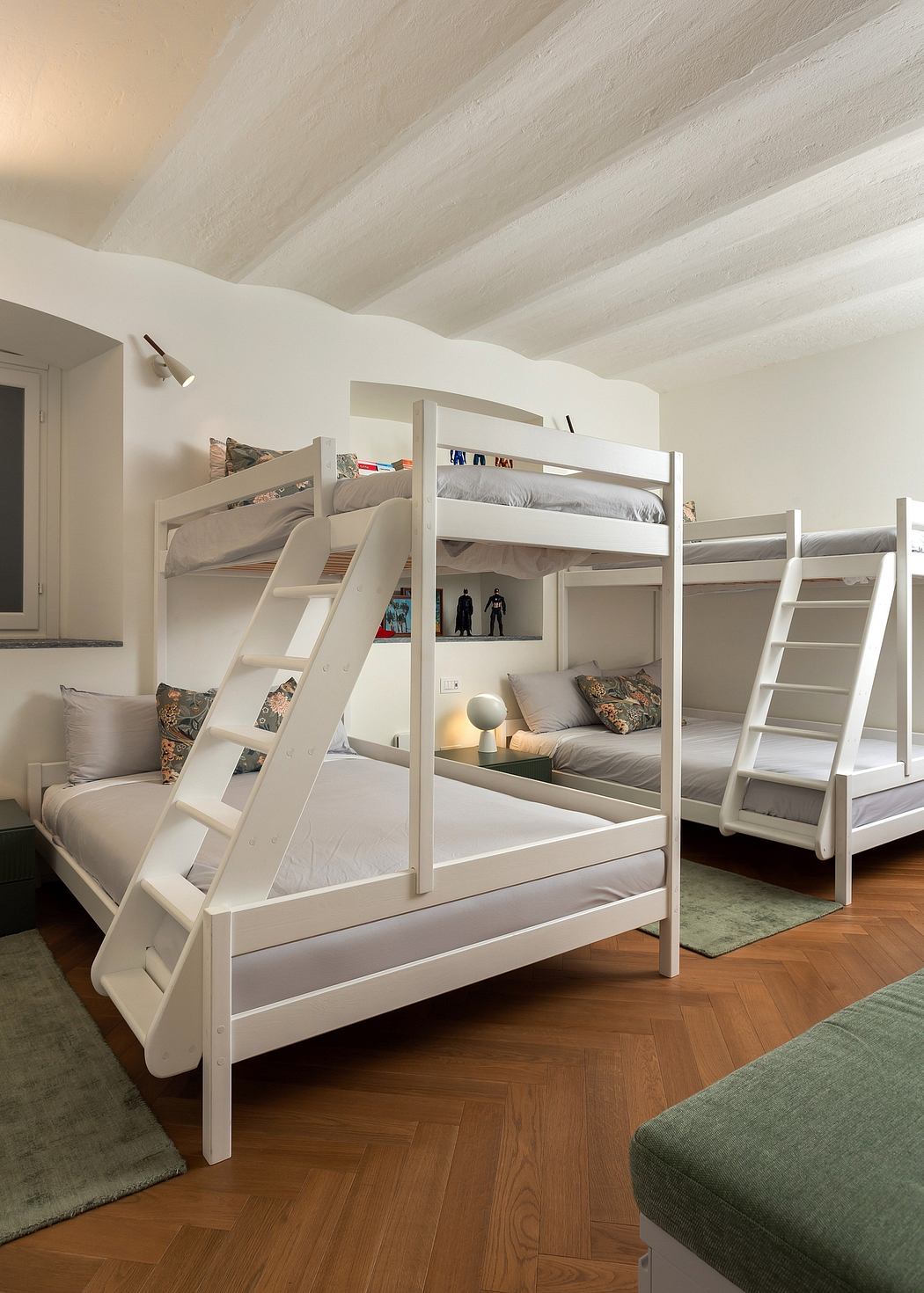 Minimalist bunk bed arrangement with built-in storage and cozy bedding.