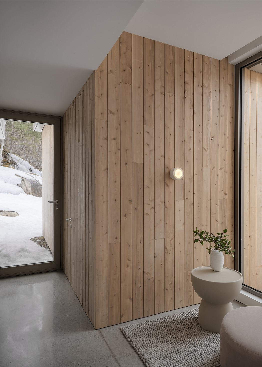 Cozy wooden interior with minimalist decor and scenic window view.