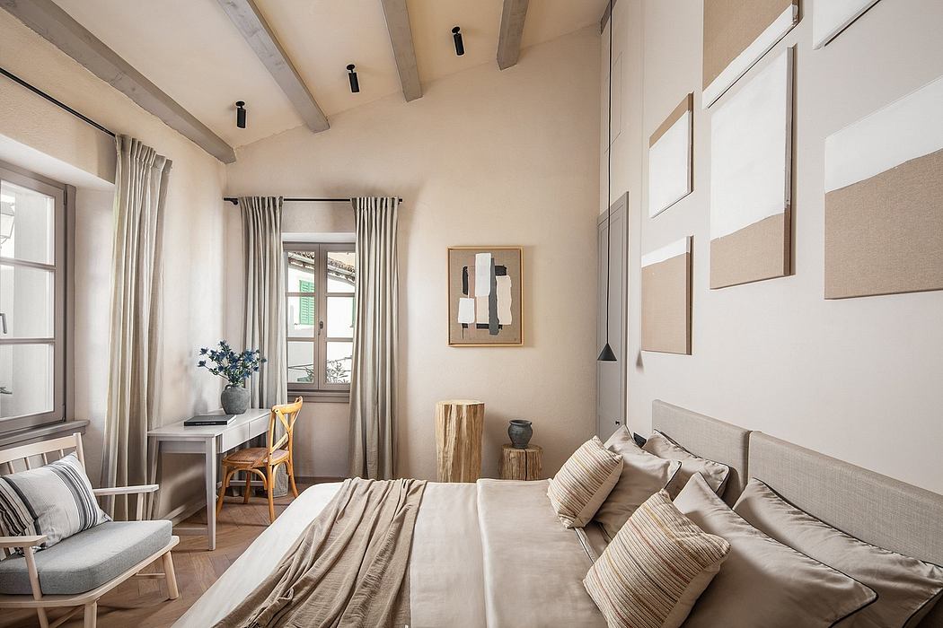 Cozy bedroom with wooden beams, plush bedding, and a mix of modern and rustic decor.