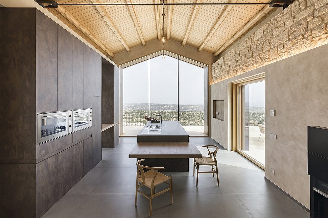 Modern, minimalist kitchen and dining area with large windows offering sweeping views.