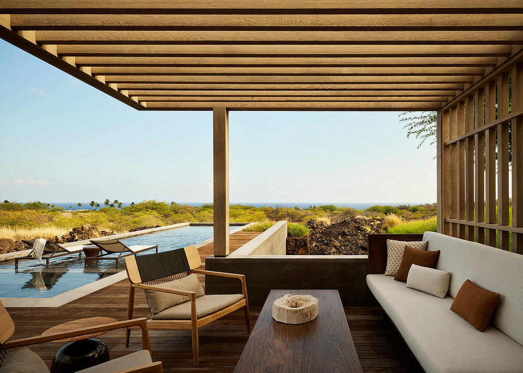 Rustic wooden pergola structure with lounge seating and outdoor pool overlooking lush landscape.