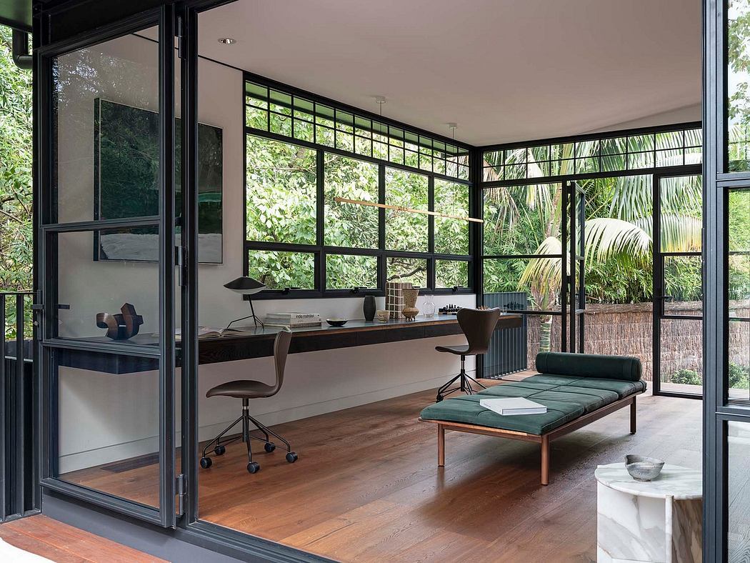 Expansive glass walls frame a modern workspace with lush garden views.