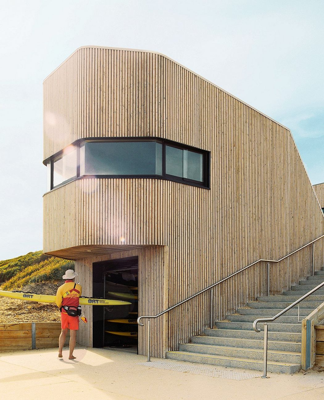 Striking modern wooden building with large windows and steps leading to the entrance.