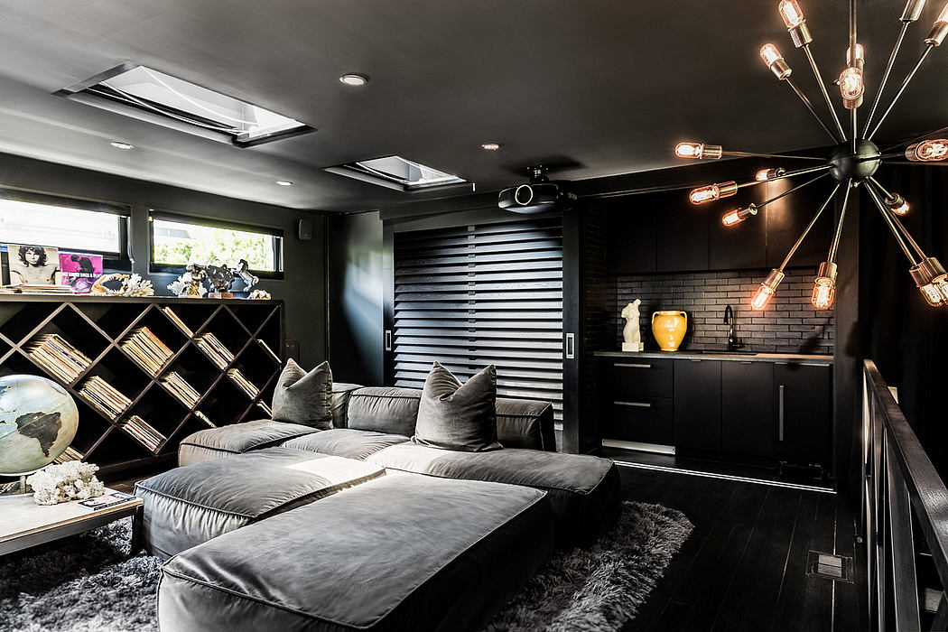 Dramatic, industrial-inspired living room with sleek black furniture, lighting, and decor.