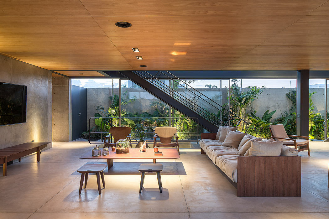 Warm, modern living space with lush greenery, large windows, and cozy furnishings.
