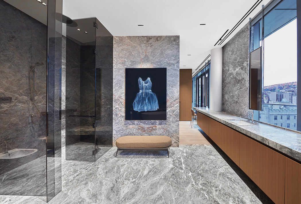 Luxurious modern bathroom with sleek glass shower, marble walls, and a framed digital artwork.