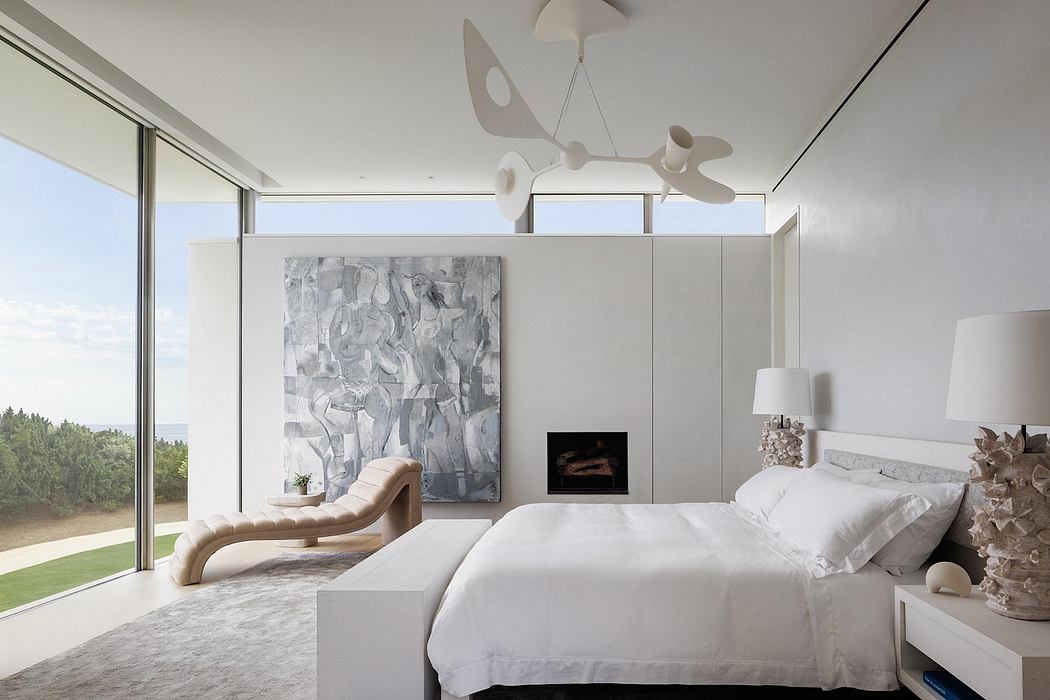Serene, modern bedroom with abstract art, sculptural lighting, and cozy lounge chair.